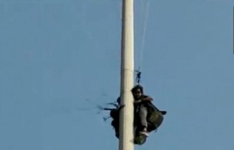Paragliding woman and trainer trapped in electric pole